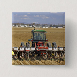 Tractor pulling a seed corn planter. 15 cm square badge