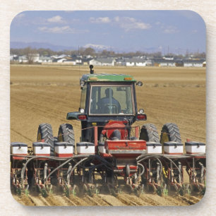 Tractor pulling a seed corn planter. coaster