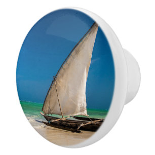 Traditional fishing boat on the beach ceramic knob