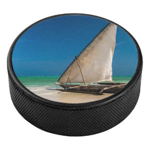 Traditional fishing boat on the beach hockey puck