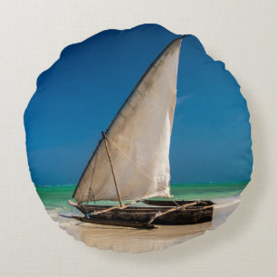 Traditional fishing boat on the beach round cushion