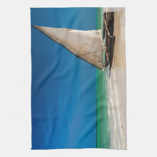 Traditional fishing boat on the beach tea towel