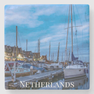 Traditional fishing town night scene. stone coaster