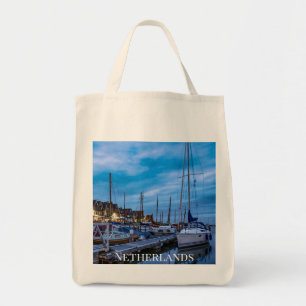 Traditional fishing town night scene tote bag