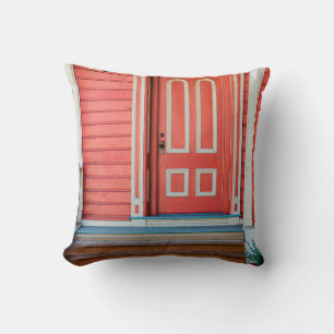 Traditional red painted wooden door and porchdoor, cushion
