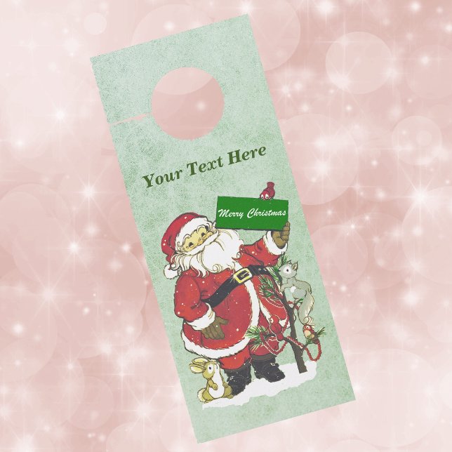Traditional Santa Tree Snow Birds Animals Green Door Hanger (Santa in snow with animals and birds holding Merry Christmas sign on paper door knob hanger.)