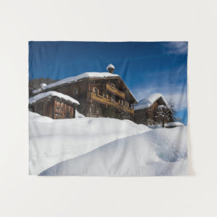 Traditional wooden cabins in de snow tapestry