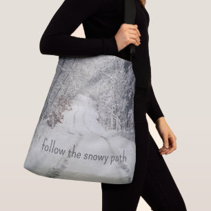 Trail through a snow-covered winter forest crossbody bag