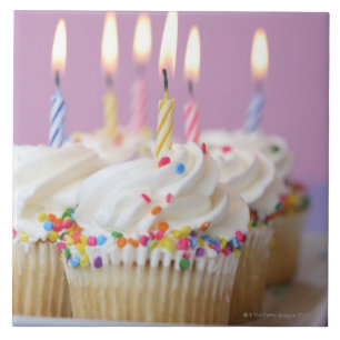 Tray of birthday cupcakes with candles tile