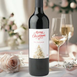 Tree snow white red script Christmas Wine Label<br><div class="desc">A white background and red text.  Decorated with a snowcovered pine tree. Merry Christmas is written with an elegant hand-lettered style script.  Personalise and add your family name and year.</div>