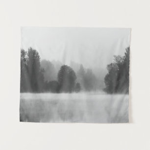 Trees disappearing in morning fog above the lake tapestry