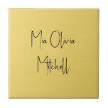 Trend Colour Soft Yellow Name Ceramic Tile<br><div class="desc">Introducing the vibrant spring shade: Soft Yellow. Elevate your home decor with our modern and stylish ceramic tile, featuring a customisable name in a charming handwritten font in classic black, looking like a signature. Its elegant and minimalist design in solid colours exudes timeless appeal, making it perfect for personal use...</div>