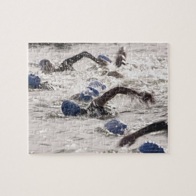 Triathletes competing in swim leg of triathlon. jigsaw puzzle (Horizontal)