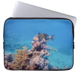 Triggerfish rests on a coral block at coral reef laptop sleeve