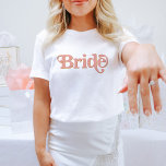 TRIXIE Retro 70's Themed Blush and Orange Bride T-Shirt<br><div class="desc">This bride bachelorette t shirt features a retro 70's themed font in blush and orange colouring. Order the white bride option for the bride-to-be and the coordinating orange 'babe' shirts for your bachelorette group. Colours are editable! Click 'edit design' to create your own colours.</div>