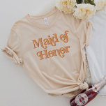 TRIXIE Retro 70's Themed Maid of Honour T-Shirt<br><div class="desc">This maid of honour t shirt features a retro 70's themed font with a creamy orange colouring. This shirt makes the perfect gift for the entire wedding party. Just search the Trixie Collection to find all coordinating text. 💜 COLORS ARE EDITABLE!  Click 'edit design' to create your own colours.</div>