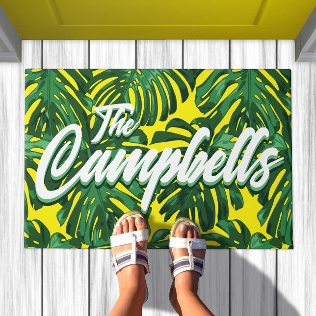 Tropical Family Name Green Yellow Monstera Leaves Doormat (Doormat with pattern of green palm leaves on yellow background. Text overlay says your family name)