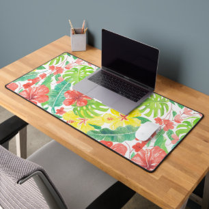Tropical garden, hibiscus plumeria and palm leaves desk mat