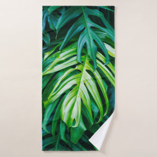 Tropical green leaves on dark background, nature s bath towel