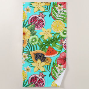 Tropical mix-fruit, flowers and leaves on blue beach towel