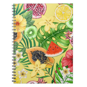 Tropical mix-fruit, flowers and leaves on yellow notebook