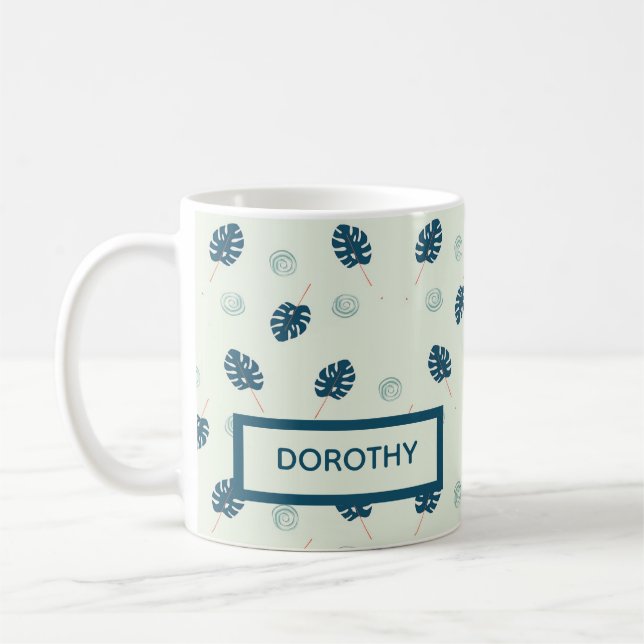 Tropical monstera leaves monogram on blue coffee mug (Left)