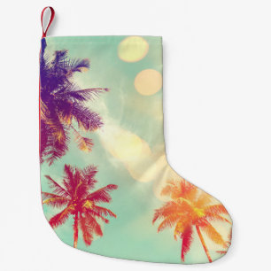 Tropical palm tree with colorful bokeh sun light o small christmas stocking