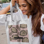 Tropical Pink & Gold Palm Leaves Pattern & Name  Tote Bag<br><div class="desc">The Tropical Pink & Gold Palm Leaves pattern features a vibrant and exotic design inspired by tropical aesthetics. The colour scheme revolves around shades of pink and gold, creating a luxurious and stylish look. The pattern consists of palm leaves rendered in a variety of sizes and orientations, evoking a sense...</div>