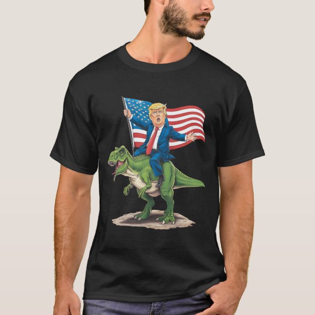 Trump Riding Dinosaur T Rex USA American Flag T-Shirt (Front)