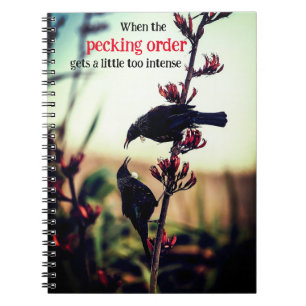 Tui birds fighting on flax notebook