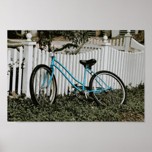 Turquoise Bicycle Leaning on a White Picket Fence Poster