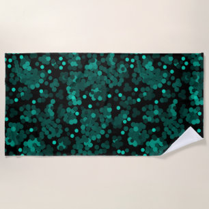 Turquoise green polka dot pattern on black beach towel