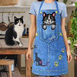 Tuxedo Cat in Faux Denim Pocket with Custom Name Apron<br><div class="desc">This fun novelty apron includes a faux (printed) denim / blue jean look and includes a cartoon black-white tuxedo kitty cat that appears as if it's sitting inside a pocket! The design also includes "patches" (printed) that resemble the silhouettes of a cat chasing a bird and three paw prints. Use...</div>