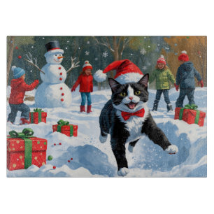Tuxedo Cat Running in Snow with Christmas Hat Cutting Board