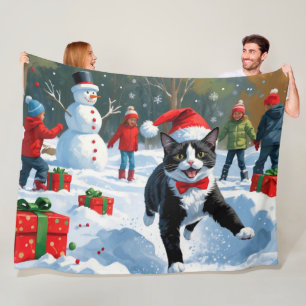 Tuxedo Cat Running in Snow with Christmas Hat Fleece Blanket