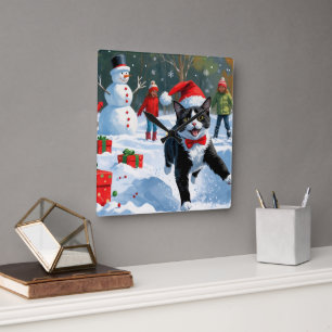 Tuxedo Cat Running in Snow with Christmas Hat Square Wall Clock