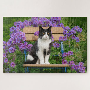Tuxedo cat sitting on a garden chair with flowers jigsaw puzzle