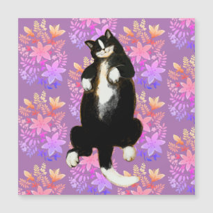 Tuxedo cat Sleeping on floral bed