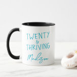TWENTY & THRIVING 20th Birthday Funny Personalised Mug<br><div class="desc">Celebrate turning twenty in style with this vibrant TWENTY & THRIVING birthday mug featuring bold turquoise lettering. This custom name coffee mug makes a fun and thoughtful gift for anyone embracing their twenties with confidence and energy. A perfect keepsake for morning coffee, dorm life, or birthday brunch. Also available in...</div>