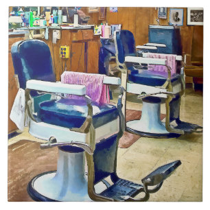Two Barber Chairs With Pink Striped Barber Capes Tile