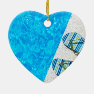 Two bathing slippers on edge of swimming pool ceramic ornament
