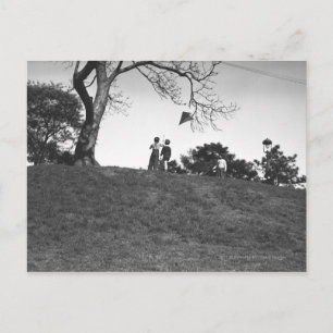Two boys flying kite on hill B&W Postcard