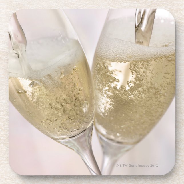 Two champagne flutes being filled with sparkling coaster (Front)