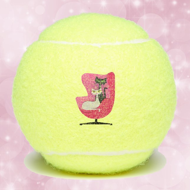 Two Elegant Mid Century Style Cats in Pink Chair Tennis Balls (Mid century style cats black and white sitting in pink chair on tennis balls.)