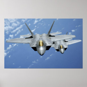 Two F-22 Raptors fly over the Pacific Ocean Poster