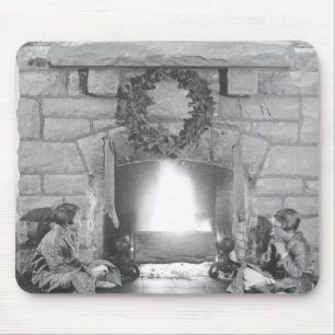 Two girls sitting by a fireplace at Christmas Mouse Pad