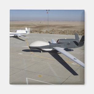 Two Global Hawks parked on a ramp Magnet