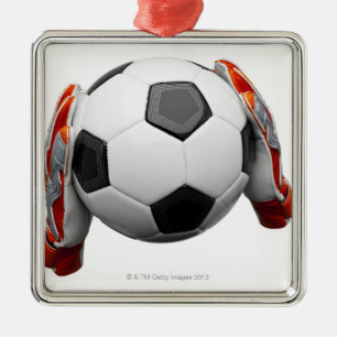 Two goal keepers gloves holding a football metal ornament