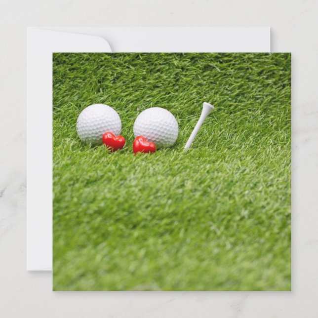 Two golf ball with two red hearts on green grass (Front)