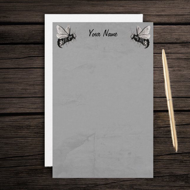 Two Gothic Bee Illustrations with Skull Wings Stationery (Two spooky black white bees skull wings on grey marbled writing stationery paper.)